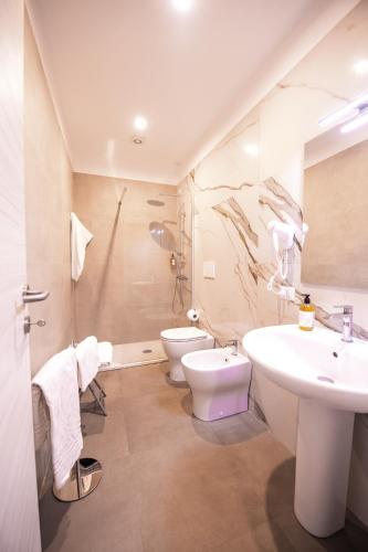 a bathroom with a sink and a toilet at La Bastia Hotel & Resort in Soriano nel Cimino