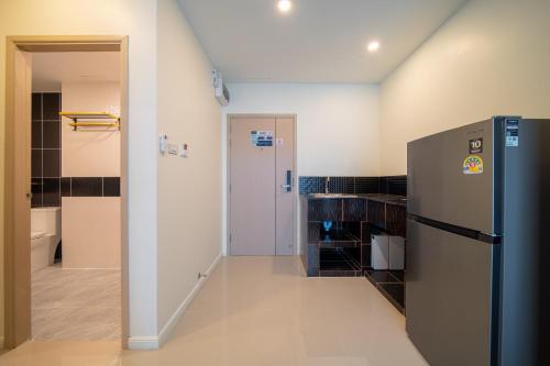 a kitchen with a refrigerator in a room at DF Hotel Pattaya in Pattaya South