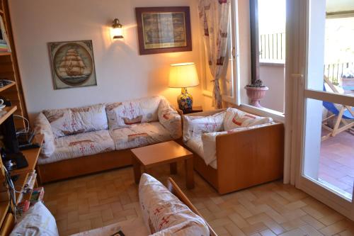 a living room with a couch and a table at Magic View in Tuscany in Capo D'Arco