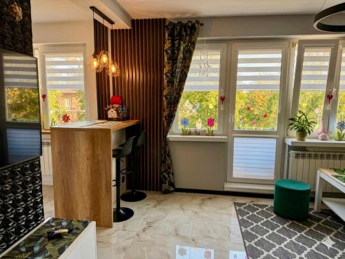 a home office with windows and a desk and a counter at Studio Modlin in Nowy Dwór Mazowiecki
