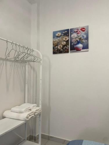 a white room with two pictures on the wall at Apartamentos Andrade in Espargos