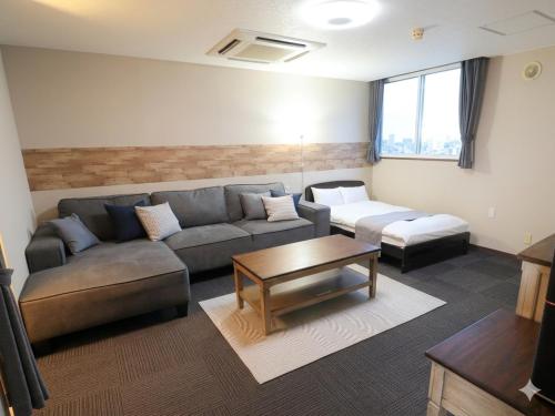 a living room with a couch and a table at A-GATE Hotel Hakodate in Hakodate