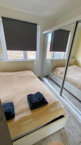 a bedroom with two mirrors and a bed in it at YoniHarmony - 2 parking places in Sosnowiec