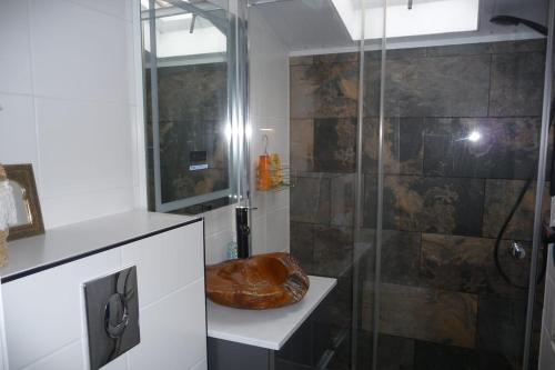 a bathroom with a shower with a wooden seat at Villa Rosa in Andijk