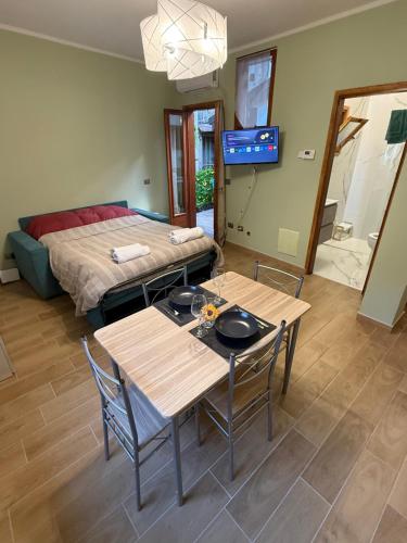 a living room with two tables and a bed at Casa vacanze by Michele in Verbania