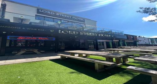a row of picnic tables in front of a building at The Lord Street Hotel; BW Signature Collection in Southport