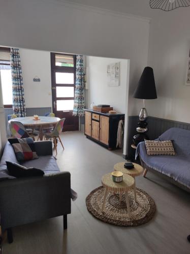 a living room with a couch and a table at L Atelier de papa in Dargnies