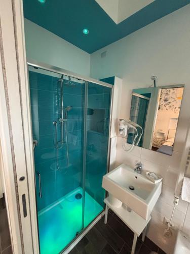 a bathroom with a glass shower and a sink at CIVICO 29 in Pompei