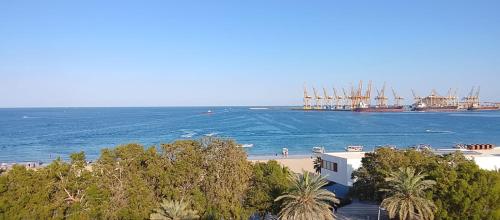 a view of the ocean and a beach with a ship at Coral Bay 1 Bedroom apartment