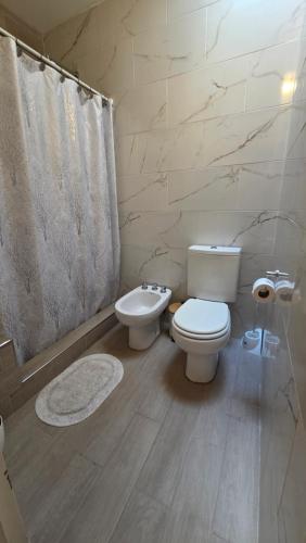 a bathroom with a toilet and a sink at Casa Golfo Nuevo in Puerto Madryn