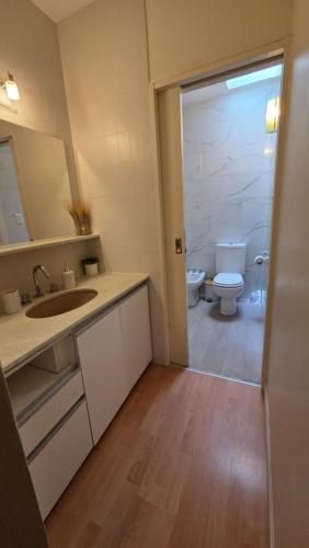 a bathroom with a sink and a toilet at Casa Golfo Nuevo in Puerto Madryn