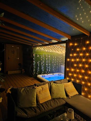 a room with a couch and a bed with lights at Drum Farm Hideaways in Carron