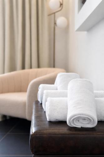 a pile of towels on a table in a living room at NOHO Boutique Koukaki , premium living in Athens
