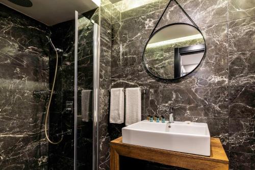 a bathroom with a sink and a mirror at Zalel Hotels Laleli in Istanbul
