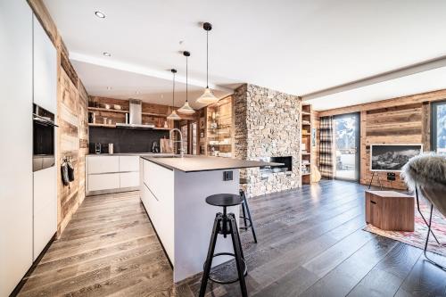 a kitchen with wooden floors and a counter with a bar at Apartment Clano, Châtel - by EMERALD STAY in Châtel