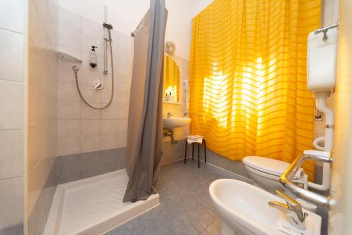 a bathroom with a shower and a sink and a toilet at LUDO Holiday House in Riccione