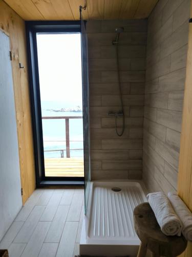 a bathroom with a shower with a glass door at Mirada al Mar in Matanzas