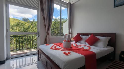 a bedroom with a bed and a large window at Kandy Alpine Breeze in Kandy