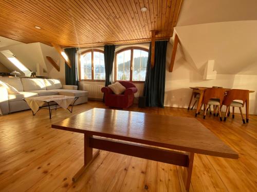 a living room with a table and a couch at Hunters Lodge in Liptovská Lúžna