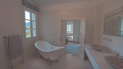 a bathroom with a tub and two sinks and a bath tub at Villa Regina in Sala Comacina