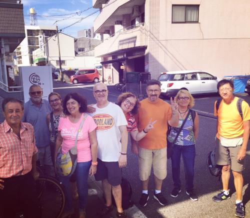 a group of people posing for a picture on a street at OUCHI HOTEL Yokogawa in Hiroshima