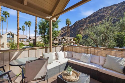 a patio with a couch and a table and chairs at Desert Escape with Private Balcony condo in Indian Wells
