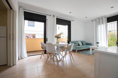 a kitchen and living room with a table and chairs at INASS in Sitges