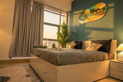 a bedroom with a large bed and a window at Spectrum Mall 1BHK Balcony Suite in Noida