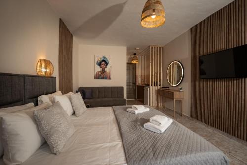 a bedroom with a large bed with towels on it at Aggire Summer Suites in Alikanas