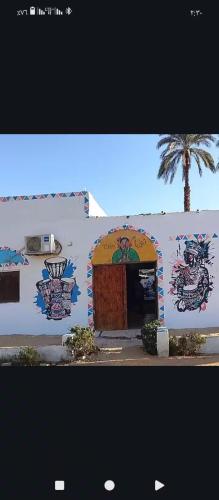 a building with graffiti on the side of it at Turia Hotel in Aswan