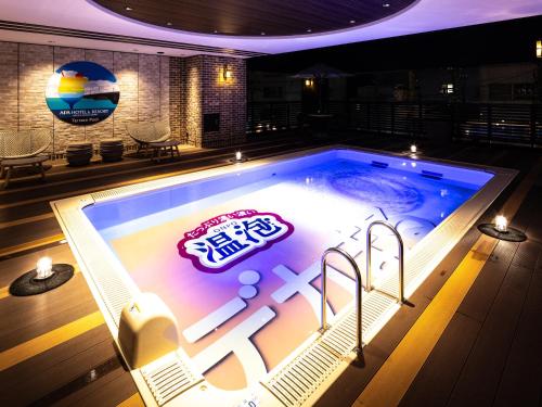 a swimming pool with a sign in the middle at APA Hotel & Resort Niigata Ekimae Odori in Niigata