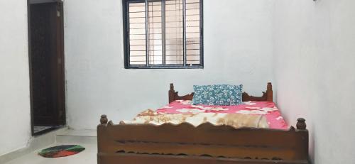 a bedroom with a bed with a pillow on it at Pie Restuarant and HomeStay in Baihar