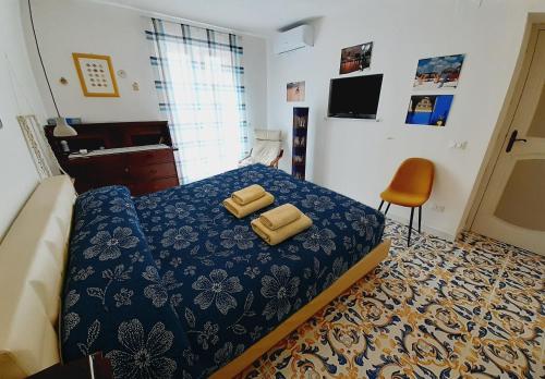 a bedroom with a bed with yellow pillows on it at Villetta Ninì in Ischia Town