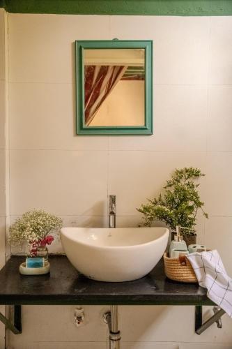 a white bowl sink on a counter with a mirror at Luxury 3BHK Pool Villa Near Beach Pondicherry in Pondicherry