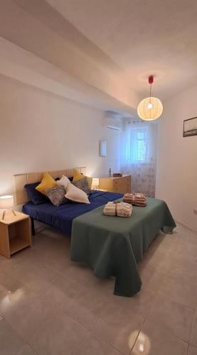 a bedroom with two beds and a table at Casa Blu Mare privat beach 9 person in San Nicola Arcella