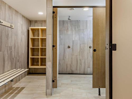 a bathroom with a walk in shower and a door at 3 Bed in Bude oc-trvvv in Poughill