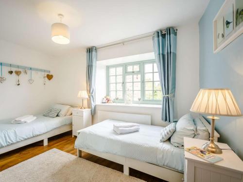 a bedroom with two beds and a window at 2 Bed in Harmby Nr Leyburn oc-g0136 in Hornby