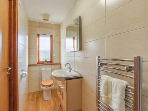 a small bathroom with a toilet and a sink at 4 Bed in Morpeth oc-86132 in Warkworth