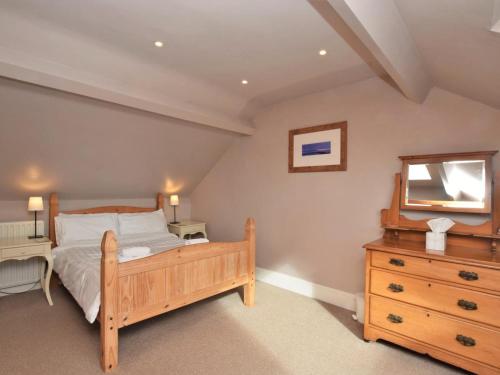 a bedroom with a bed and a dresser and a mirror at 3 Bed in Morpeth oc-cn137 in Amble