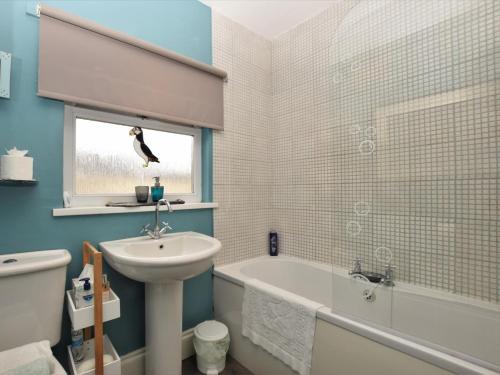a bathroom with a sink and a toilet and a bath tub at 3 Bed in Morpeth oc-cn137 in Amble
