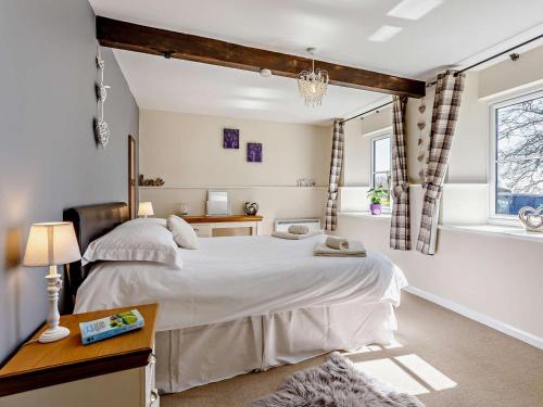 a bedroom with a large white bed and a window at 1 Bed in Dulverton oc-lbard in Dulverton