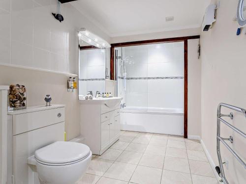 a white bathroom with a toilet and a shower at 1 Bed in Dulverton oc-lbard in Dulverton