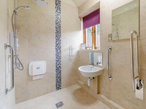 a bathroom with a sink and a shower at 3 Bed in York oc-83264 in High Catton