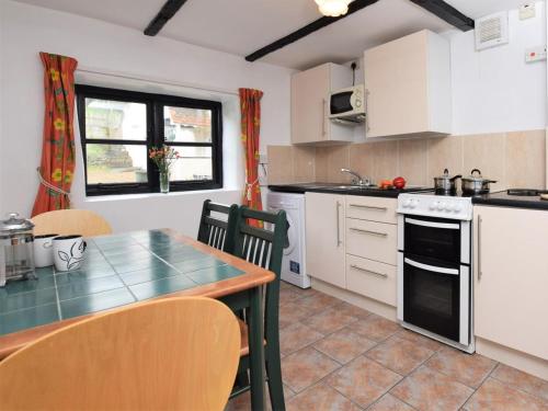 a kitchen with a table and a counter top at 2 Bed in Bridgwater oc-alden in Kilve