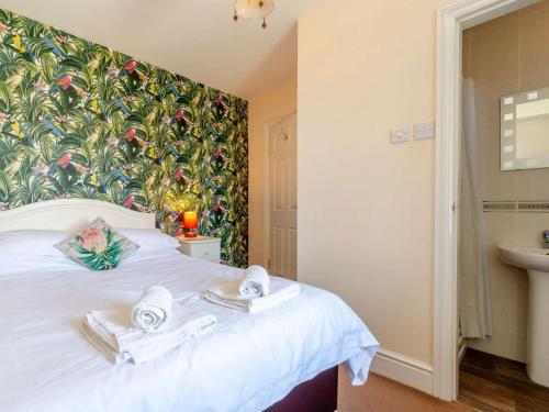 a bedroom with a white bed with towels on it at 3 Bed in Harrogate oc-hh056 in Harrogate