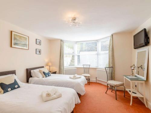 a bedroom with two beds and a desk and a tv at 3 Bed in Harrogate oc-hh056 in Harrogate