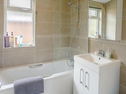 a bathroom with a tub and a sink and a shower at 2 Bed in Bridlington oc-79429 in Sewerby