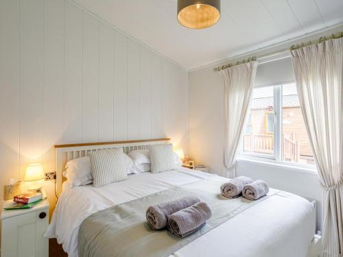 a bedroom with a large white bed with towels on it at 2 Bed in Bridlington oc-79429 in Sewerby