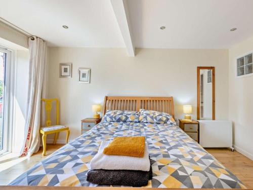 a bedroom with a bed with a blue and yellow comforter at 3 Bed in Yeovil oc-htorv in Castle Cary