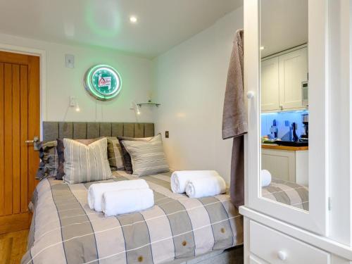 a bedroom with a bed with two pillows on it at 1 Bed in Christchurch oc-90444 in Highcliffe